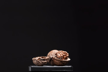 close-up of walnuts on black background.