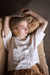 Attractive young girl lying on a couch