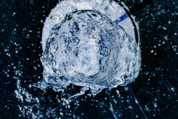 Water jet going up towards the camera, blue tones, background for hydrological concept.