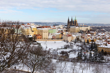 Snowy Prague City with gothic Castle from Hill Petrin in the sunny Day, Czech republic
