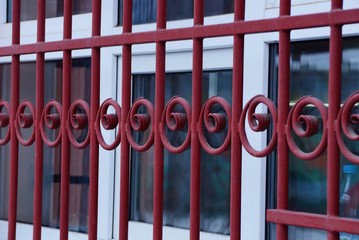 metal texture of red forged rods with a pattern on the window