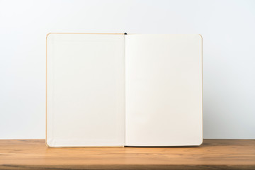 Perspective view of kraft notebook on wood floor
