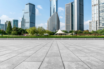 Empty square floor tiles and skyline of modern urban buildings in Shanghai..