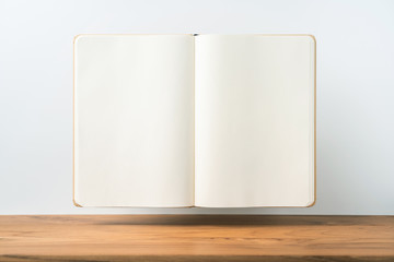 Perspective view of kraft notebook on wood floor