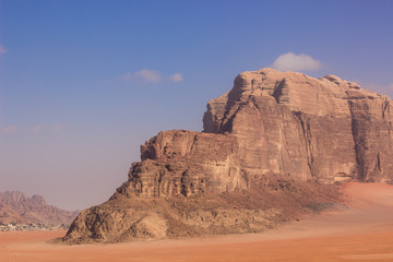 Fototapeta na wymiar Middle East steep picturesque rock mountain yellow scenic landscape in Wadi Rum desert 