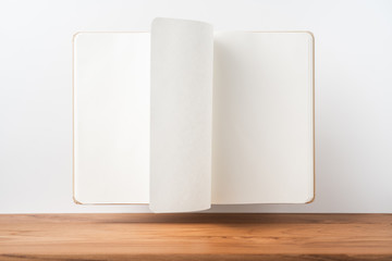 Perspective view of kraft notebook on wood floor