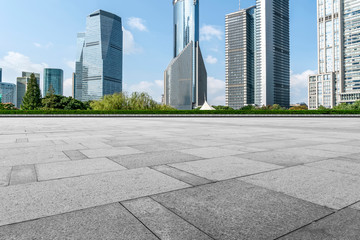Fototapeta premium Empty square floor tiles and skyline of modern urban buildings in Shanghai..