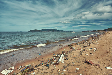 Fototapeta na wymiar Heavily polluted with plastic garbage tropical beach