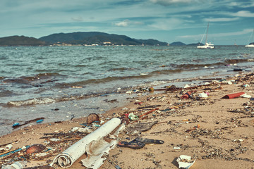 Heavily polluted with plastic garbage tropical beach