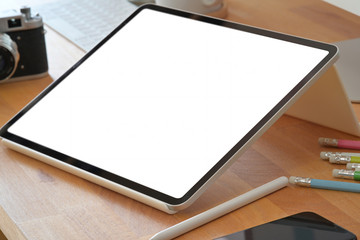 Workspace wood office desk with mockup blank screen tablet