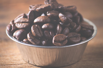 Coffee beans on a wooden background. Copy space.
