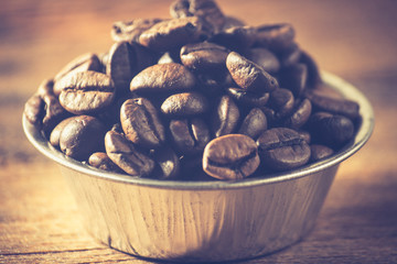Coffee beans on a wooden background. Copy space.