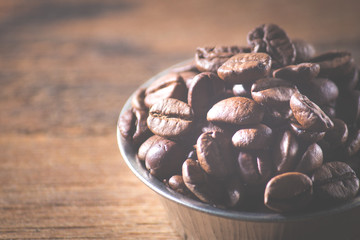 Coffee beans on a wooden background. Copy space.
