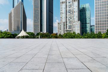 Empty square floor tiles and skyline of modern urban buildings in Shanghai..