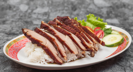 Fried pork with garlic or steak on rice and cucumber.