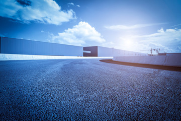 Road asphalt pavement and modern factory warehouse..