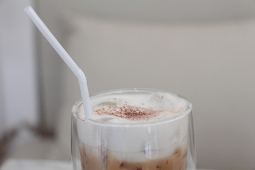 milk on top of iced coffee on white background. 