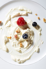 Whipping cream,nuts and berries on plate