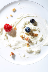 Whipping cream,nuts and berries on plate