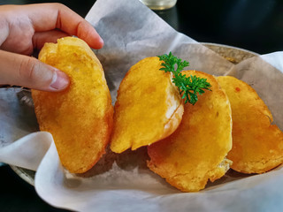 Close-up Hand Picking A Slice of Garlic Bread