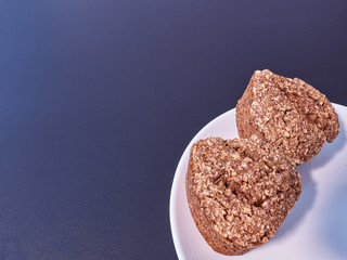 high-quality bread from sprouted wheat heart shape on a white plate of Chinese porcelain on a black background. homebaked bread. healthy food. copy space