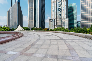 Empty square floor tiles and skyline of modern urban buildings in Shanghai..