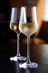 Glasses of white wine on table