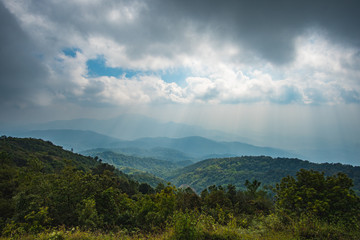 The beautiful scenery of tropical forest at Southeast Asia with mountain and cloudy background