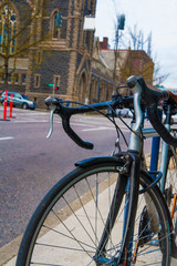 Fototapeta premium Worn bicyle parked on a sidewalk in the city