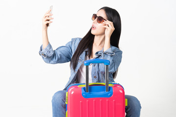 Traveler tourist woman in summer casual clothes.Asian Smiling woman wearing sun glasses.Passenger traveling abroad to travel on white background.