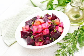 Salad of beets and potatoes in plate on light table