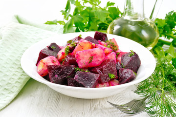 Salad of beets and potatoes in plate on table