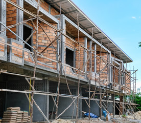 Two storey houses with wood scaffolding are under construction in Thailand, modern house design