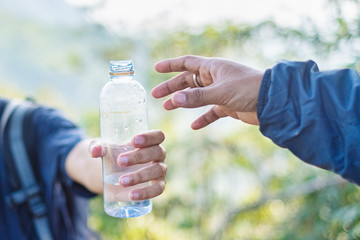 Close-up of hand give water to each other. Friend forever.