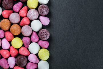 chewing gum, candy, chewing candy and other sweets on black background