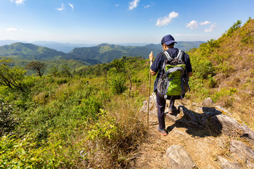 Young  man standing taking a rest after long walk of trekking. Mountain in Thailand, Khao Chang Puak in Kanchanaburi province.