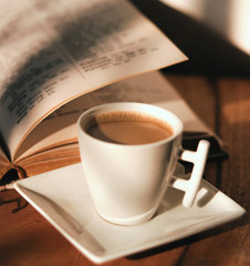 warm cup of coffee on brown background