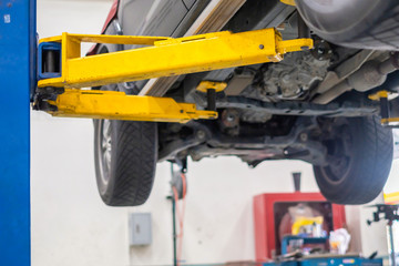 Fototapeta premium a car is on lifting platform for repair