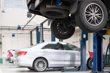 Car lift up for repair at car repair service shop