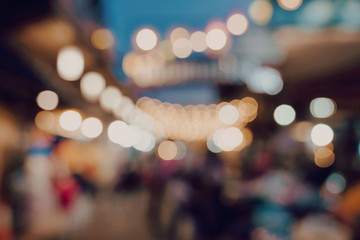 blurred background at night market festival people walking on road.