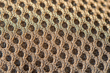 Golden dotted texturised technological seamless fabric or surface closeup