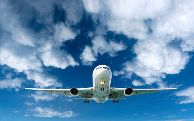 Passenger Airliner Airplane flying in the sky white clouds