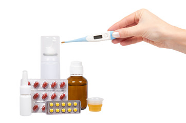 Bottle with medicine, nasal spray with hand. Antipyretic syrup and pills. Medication for cold treatment