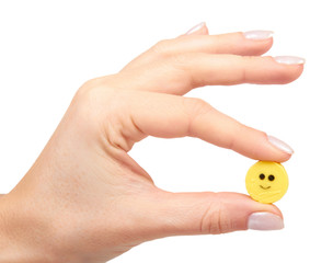 Hand with colored round candy, sugar lollipop