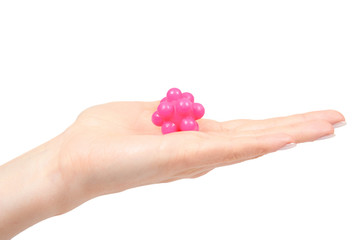 Hand with pink spiky ball for massage, healthcare concept