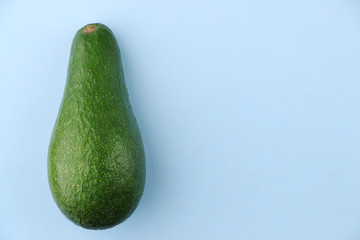 whole avocado on a light blue background