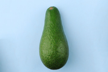 whole avocado on a light blue background