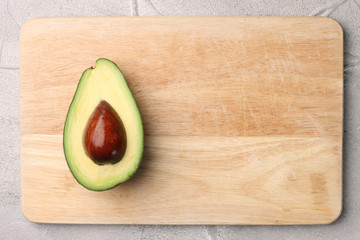 half avocado on wooden background top view