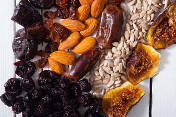 dried super foods on white wood table background