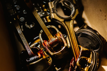 Fototapeta premium Engine overhaul. Broken engine pistons are boxed and smeared in oil
